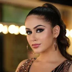 The complete look, with bold eyes, a defined contour, and a glossy nude lip.