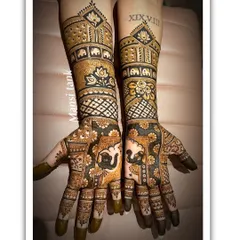 A beautiful example of combining modern and traditional styles for an engagement. This design features bold elephants, lotus motifs, and sharp check patterns, all with a rich, dark henna stain.