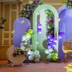 Another view of the pastel-themed backdrop, featuring a cute baby carriage prop and butterfly accents. This setup is perfect for capturing precious memories of the celebration.