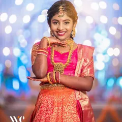 A full-length shot showcasing the beautiful traditional attire at a half-saree function. We pay attention to the details, ensuring the outfit, jewelry, and decor are all captured beautifully.
