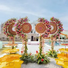 A Haldi carnival that is bursting with color and energy. The decor features unique floral structures and traditional elements, creating a visually stunning and joyful setting for the ceremony.