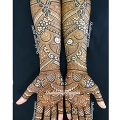 This is a non-symmetrical bridal design I did for a beautiful bride. The arms feature flowing floral patterns and geometric grids, showing that both hands can be unique yet part of a cohesive look.