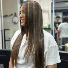 A close-up of sleek, straight hair with fine, delicate highlights. This technique adds a subtle shimmer and the illusion of thickness without a dramatic color change.