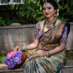 A closer look at the bridal ensemble, showing the intricate details of the temple jewelry against our traditional silk saree. The combination of the soft silk and the grand jewelry is perfect for wedding photos.