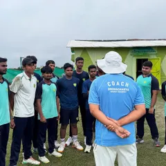 The coach's perspective. Here, our head coach addresses the team, ensuring every player is aligned and focused. This is where individual talents are molded into a cohesive, winning unit.
