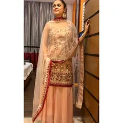This pastel sharara suit is a wonderful choice for a daytime wedding event. The soft color palette combined with delicate floral embroidery and a sheer dupatta creates a romantic and feminine look.
