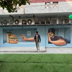 Another perspective of the full 3D mural at the cafe, showing how it occupies the length of the wall and creates a dynamic visual experience from different angles.