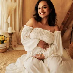 A serene and happy portrait, seated amongst the natural textures of the boho setup. This is perfect for the mom who wants a light and airy feel for her photos.