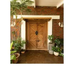 Opening doors to sustainability. This repurposed wooden door, set against an exposed brick wall, showcases the elegance of recycled materials and our commitment to reducing our carbon footprint.