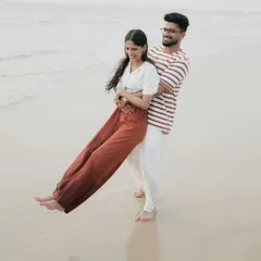 A playful lift on the wet sand, creating beautiful reflections. Beach photoshoots are all about having fun and being yourselves.