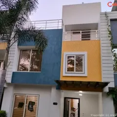 This modern villa's exterior was transformed with a durable, weather-resistant paint combination. We used a sophisticated palette of blue, yellow, and white to enhance the building's architectural features and provide long-lasting curb appeal.