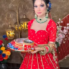 The model is holding the traditional Karwa Chauth thali, showcasing the complete festive look. The red lehenga and matching jewellery are available for rent.