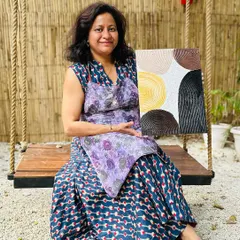 A participant proudly displays her finished texture art piece. She created a beautiful composition of circles with intricate line work, showcasing a wonderful sense of balance and color.