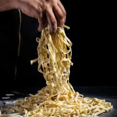 There's nothing quite like the magic of fresh pasta. Here, we showcase our handmade fettuccine, ready to be transformed into a delicious dish at our live pasta bar.