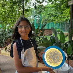 There's nothing more magical than seeing a child's face light up with their own creation. This young artist is so proud of the glowing moon lamp she made at a birthday party workshop.