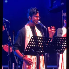 Focused and in the zone, providing harmony vocals during a live concert. My classical training helps me adapt my voice to blend perfectly within a choir for arena shows.