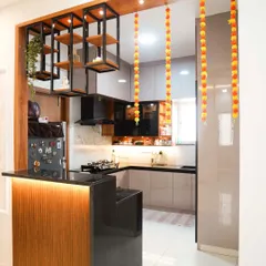 This modern open-concept kitchen features a stylish breakfast bar, perfect for casual meals and entertaining. We designed it with sleek, handleless cabinets, under-cabinet lighting, and a striking combination of wood and high-gloss finishes for a clean, contemporary look.