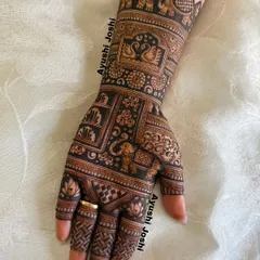 A close-up of one hand from the Karva Chauth design, showing the detail in the elephant and swan motifs.