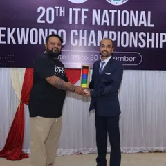 Receiving a memento while officiating at the 20th National Taekwon-Do ITF Championship. Being an official is a critical role that upholds the integrity and fairness of the sport.