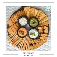 Our Chip and Dip Platter is perfect for casual get-togethers. It features an assortment of crispy crackers, lavash, and chips served with four different freshly made dips, including hummus and creamy yogurt-based options.