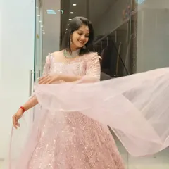 A candid shot of a client enjoying a twirl in the pink embroidered gown. The sheer joy and elegance this gown brings is clear to see.