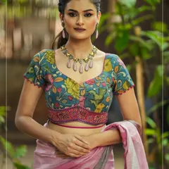 A closer look at the beautiful floral Kalamkari pattern on this teal blouse. The sweetheart neckline and princess cut ensure a perfect fit, while the hand-painted design makes it a standout piece.