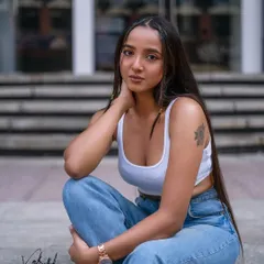 A seated portrait from our urban fashion shoot. This pose feels relaxed and contemplative, offering a different mood while still maintaining a cool, street-style aesthetic.