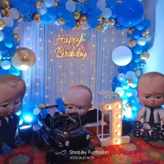 For a first birthday, a Boss Baby theme is always a hit. We created this complete setup with a blue and gold balloon arch, character cutouts, a light-up marquee number '1', and a 'Happy Birthday' neon sign.