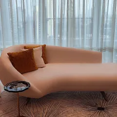 This bespoke chaise lounge embodies our philosophy of sculptural comfort. Its fluid, organic form provides an elegant focal point, while the plush upholstery invites relaxation, proving that true luxury lies in the perfect balance of form and function.
