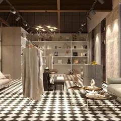 This view shows a curated retail display that feels like a chic living room. The design uses clothing racks and shelving to blend fashion with furniture, creating a holistic lifestyle experience.