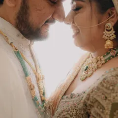 An intimate and romantic close-up, capturing the couple just a moment before a kiss. The bright backlighting creates a dreamy, ethereal feel.
