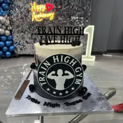 Train hard, treat harder! A custom cake designed for the first anniversary of a gym, featuring their logo and a fitness theme.