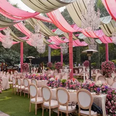 For this garden luncheon, I created a beautiful canopy of flowing pink and olive green drapes, with crystal chandeliers interspersed throughout. The setup provided shade while adding a layer of elegance and color to the outdoor space.