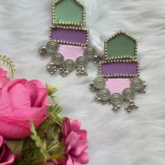 These long fabric earrings are perfect for handmade jewellery lovers. I've used three colours of fabric, green, purple, and pink, and combined them with oxidised silver charms for a unique, lightweight design.