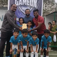 The team receives their winners' plaque, a proud moment for our youngest group of footballers.