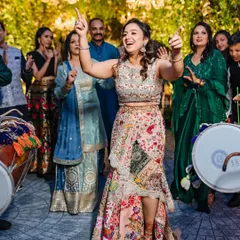 A bride dances with pure abandon to the beat of the dhol, her energy lighting up the Mehendi celebration in Chandigarh.