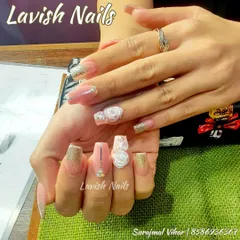 A stunning bridal design with 3D sculpted white roses, gold glitter ombre, and delicate rhinestone accents on long, elegant nails.