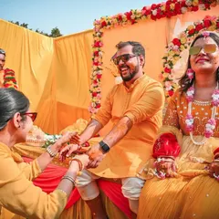 We focus on capturing the interactions between you and your loved ones. This shot shows a family member performing a ritual during the Haldi, with the couple enjoying the moment.