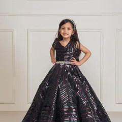 For a modern and glamorous look, we created this black taping gown. The full, structured skirt and geometric sequin pattern make it a showstopper, perfect for birthdays, pageants, or any formal event where she wants to shine.