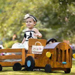 All aboard the teddy bear express for a first birthday adventure. I love taking shoots outdoors to use beautiful natural light. This custom-built train prop is just one of the many ways I bring big, imaginative ideas to life for your child's milestone celebration.