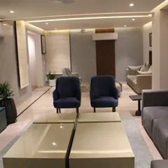 A wider view of the Hyderabad living area, showing how the different furniture pieces create a cohesive and spacious seating arrangement. The neutral color palette is accented with touches of blue and wood.