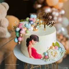 A close-up of a custom baby shower cake, adorned with an illustration of the mother-to-be. These personalized details are what make your celebration special, and I make sure to photograph them.