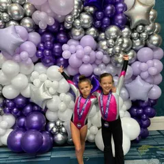 A moment of pure joy and achievement at the USAIGC Worlds in Orlando. Our gymnasts celebrate their performance against a backdrop of balloons, a memory they will cherish forever from their international competitive experience.