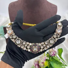 A hand-held view of the kundan choker, showing its flexibility and the shine of the stones.