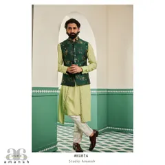 For festive occasions like a mehendi or sangeet, we design layered ensembles that are both elegant and comfortable. This look features a light green drape kurta paired with a contrasting emerald Nehru jacket, which is covered in our exquisite floral hand-embroidery.