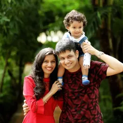 A classic family pose with a happy toddler perched on dad's shoulders during a park photoshoot. Outdoor sessions give us the freedom to capture both posed and spontaneous moments in a vibrant setting.