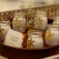 Our Coconut Punch is a creamy and refreshing hug in a glass. Served in charming jars with personalized initial tags, it adds a thoughtful and stylish touch to your event.