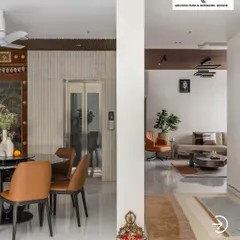 Here you can see how I create flow in an open-plan layout. The dining area is distinct yet connected to the living space, unified by a consistent color palette and flooring, while a central pillar adds architectural interest.