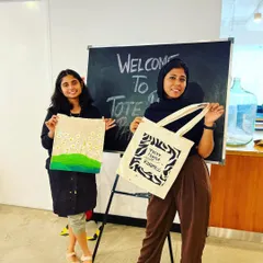 A proud moment from our tote bag painting workshop. These two participants are showing off their gorgeous, hand-painted bags.