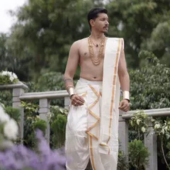 A candid shot of the groom. The jewellery is designed to be elegant and masculine, completing the wedding day look.
